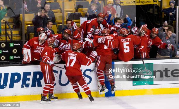 The Boston University Terriers celebrate an empty net goal by Bobo Carpenter against the Providence College Friars during NCAA hockey in the Hockey...