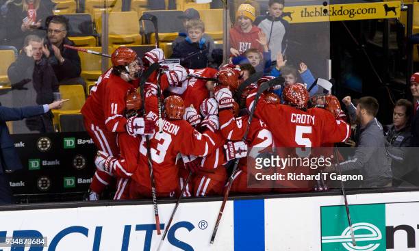 The Boston University Terriers celebrate an empty net goal by Bobo Carpenter against the Providence College Friars during NCAA hockey in the Hockey...