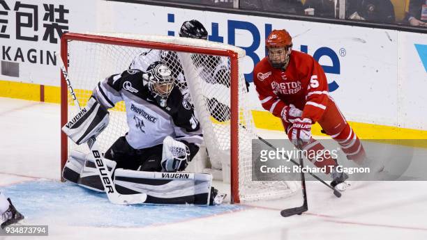 Shane Bowers of the Boston University Terriers skates behind Hayden Hawkey of the Providence College Friars during NCAA hockey in the Hockey East...