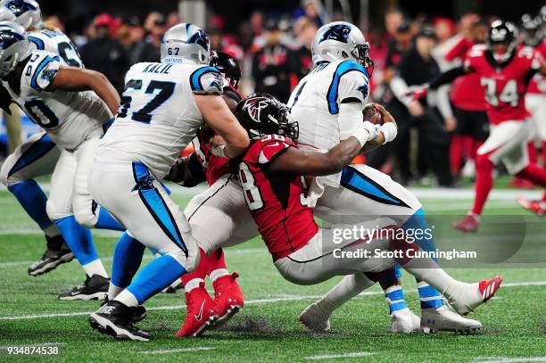 Takkarist McKinley of the Atlanta Falcons tackles Cam Newton of the Carolina Panthers during the first half at Mercedes-Benz Stadium on December 31,...