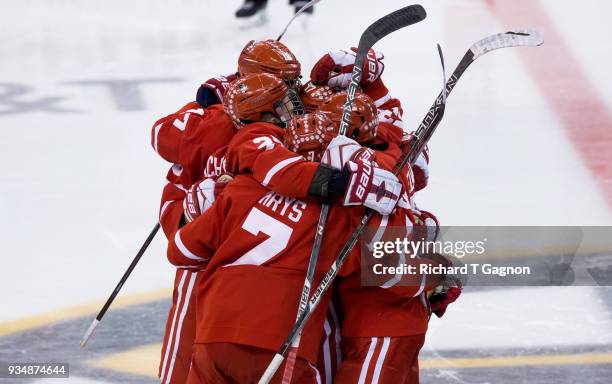 Drew Melanson of the Boston University Terriers celebrates his goal against the Providence College Friars with his teammates Jordan Greenway, Brady...