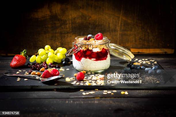 muesli with red fruit jelly, chia, curd, raspberry, almond, cranberry, blue berry, dried banana, grape - almond jelly stock pictures, royalty-free photos & images
