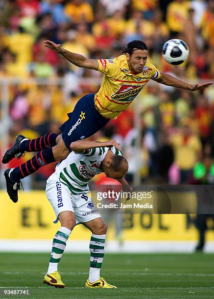 Mauricio Romero of Monarcas Morelia vies for the ball with Carlos Ochoa of Santos Laguna during their match as part of the 2009 Opening Tournament in...