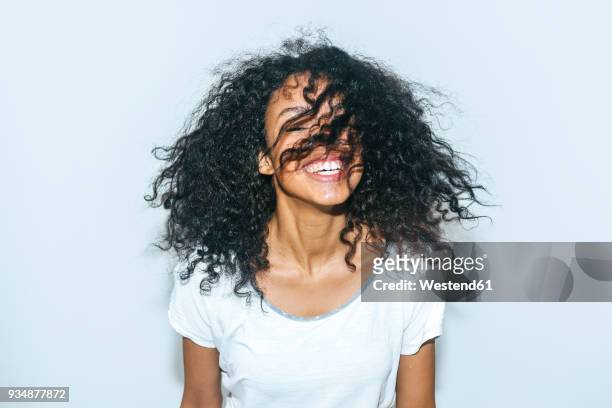 portrait of laughing young woman - afro hairstyle stock pictures, royalty-free photos & images