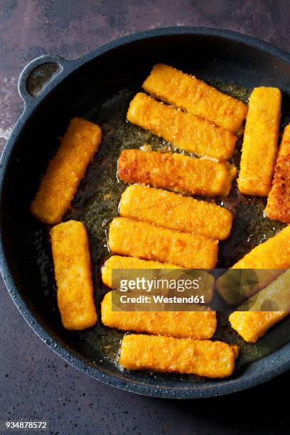 fish fingers in frying pan - fish stick stock pictures, royalty-free photos & images