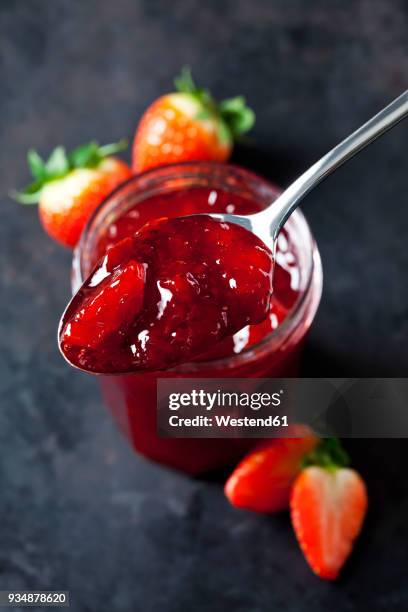 spoon of strawberry jam, close-up - strawberry jam stock pictures, royalty-free photos & images