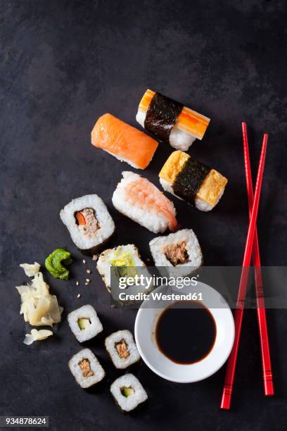 variety of sushi with wasabi, ginger and bowl of soy sauce on dark ground - boiled shrimp stock pictures, royalty-free photos & images