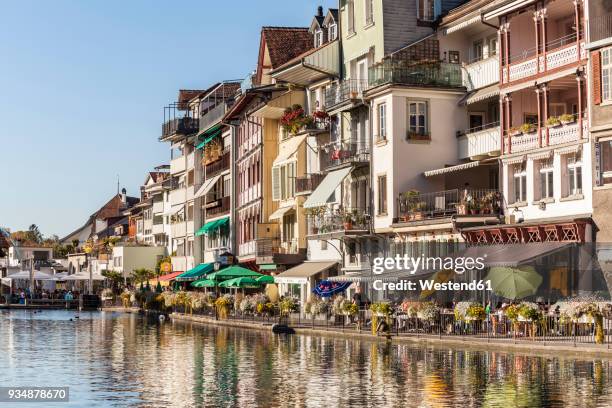 switzerland, thun, row of houses with pavement cafes and restaurants at riverside of aare - berne ストックフォトと画像