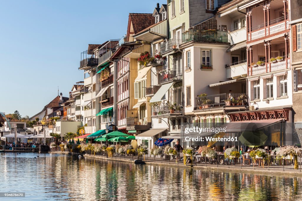 Switzerland, Thun, row of houses with pavement cafes and restaurants at riverside of Aare