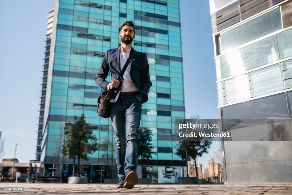 Businessman walking outside office building