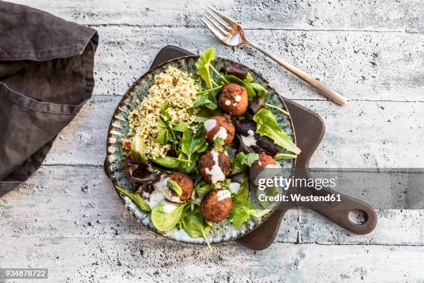 plate of falafel, salad, yogurt sauce with mint and tabbouleh - tabbouleh stock pictures, royalty-free photos & images