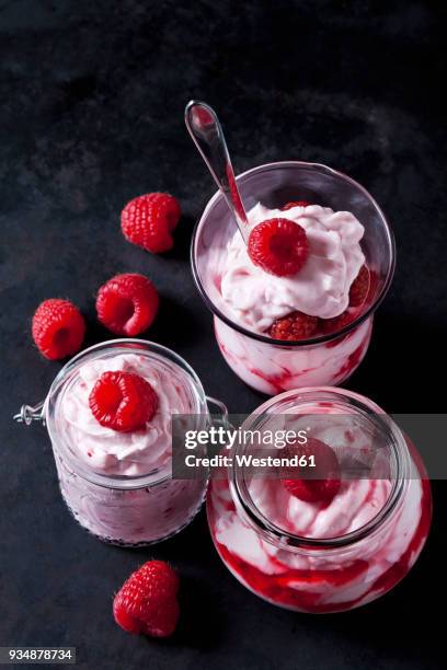 trifle of whipped cream with strawberries and strawberry sauce in various glasses - raspberry coulis stock pictures, royalty-free photos & images