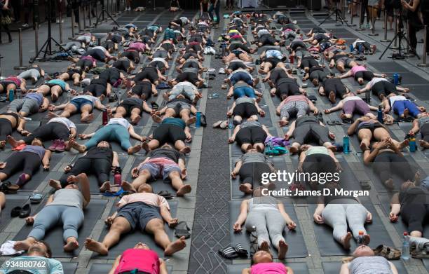 Sydneysiders take part in a mass yoga session on Pitt Street in Sydney's CBD during the evening rush hour on March 20, 2018 in Sydney, Australia. The...