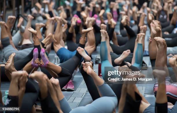 Sydneysiders take part in a mass yoga session on Pitt Street in Sydney's CBD during the evening rush hour on March 20, 2018 in Sydney, Australia. The...