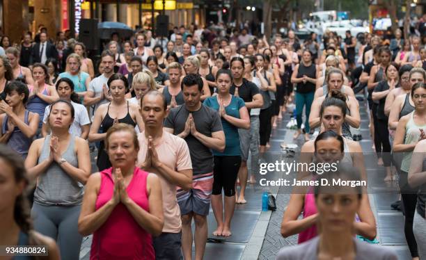 Sydneysiders take part in a mass yoga session on Pitt Street in Sydney's CBD during the evening rush hour on March 20, 2018 in Sydney, Australia. The...