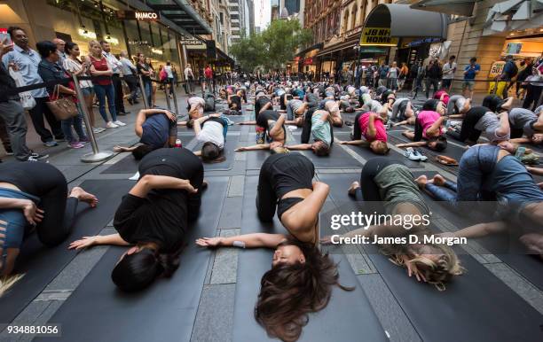 Sydneysiders take part in a mass yoga session on Pitt Street in Sydney's CBD during the evening rush hour on March 20, 2018 in Sydney, Australia. The...