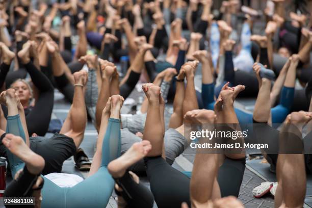 Sydneysiders take part in a mass yoga session on Pitt Street in Sydney's CBD during the evening rush hour on March 20, 2018 in Sydney, Australia. The...