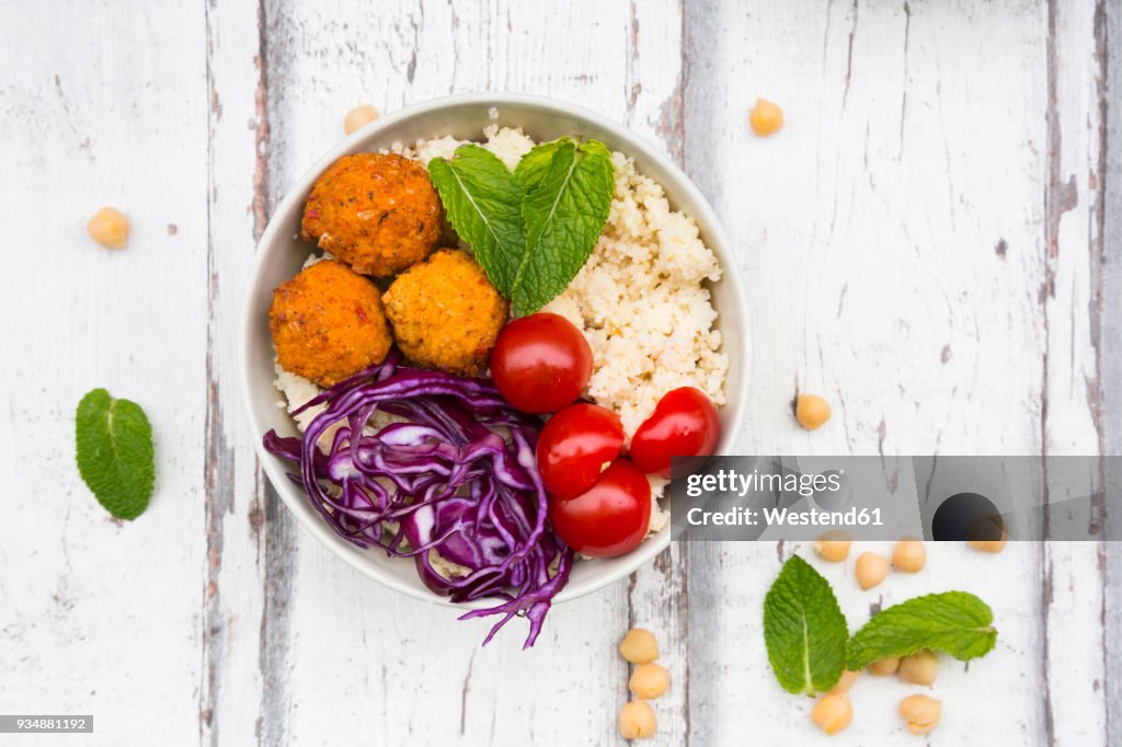 Buddha bowl of sweet potato balls, Couscous, Hummus and vegetables