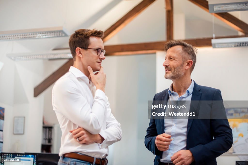 Two businessmen talking in office