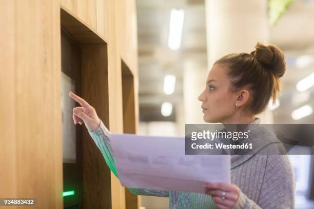 young woman working in an office - finger bun stock pictures, royalty-free photos & images