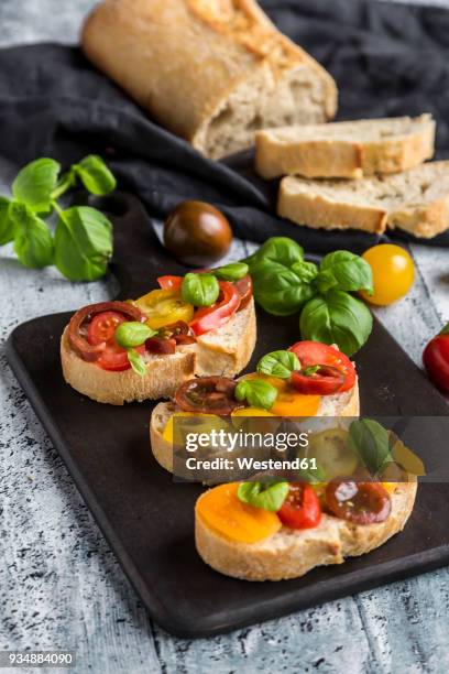 bruschetta, ciabatta with multi-coloured tomatoes and basil - ciabatta stock pictures, royalty-free photos & images