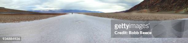a person walking alone in the remote desert of death valley - robb reece stock-fotos und bilder