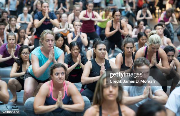 Sydneysiders take part in a mass yoga session on Pitt Street in Sydney's CBD during the evening rush hour on March 20, 2018 in Sydney, Australia. The...