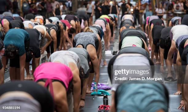 Sydneysiders take part in a mass yoga session on Pitt Street in Sydney's CBD during the evening rush hour on March 20, 2018 in Sydney, Australia. The...