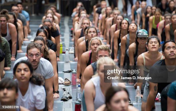 Sydneysiders take part in a mass yoga session on Pitt Street in Sydney's CBD during the evening rush hour on March 20, 2018 in Sydney, Australia. The...