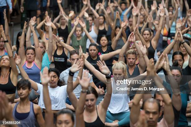 Sydneysiders take part in a mass yoga session on Pitt Street in Sydney's CBD during the evening rush hour on March 20, 2018 in Sydney, Australia. The...