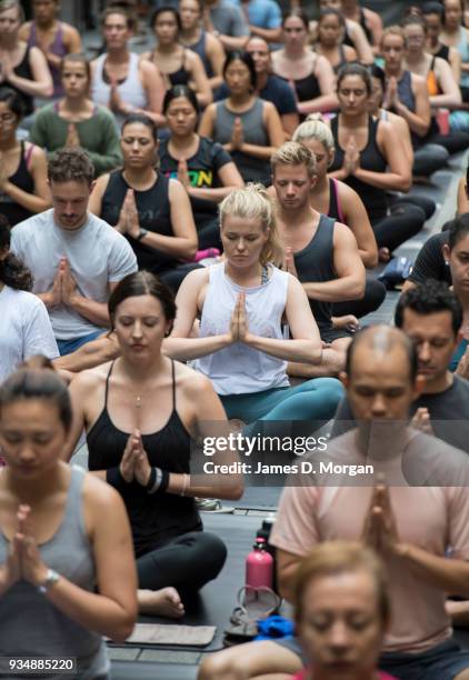 Sydneysiders take part in a mass yoga session on Pitt Street in Sydney's CBD during the evening rush hour on March 20, 2018 in Sydney, Australia. The...