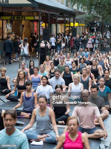 Sydneysiders take part in a mass yoga session on Pitt Street in Sydney's CBD during the evening rush hour on March 20, 2018 in Sydney, Australia. The...