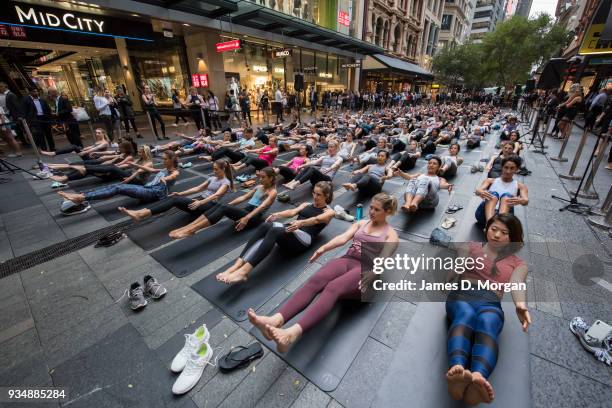 Sydneysiders take part in a mass yoga session on Pitt Street in Sydney's CBD during the evening rush hour on March 20, 2018 in Sydney, Australia. The...