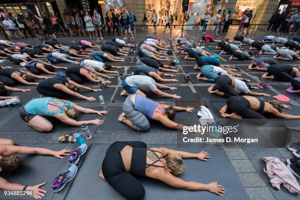 Sydneysiders take part in a mass yoga session on Pitt Street in Sydney's CBD during the evening rush hour on March 20, 2018 in Sydney, Australia. The...