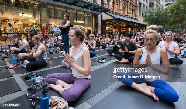 Sydneysiders take part in a mass yoga session on Pitt Street in Sydney's CBD during the evening rush hour on March 20, 2018 in Sydney, Australia. The...