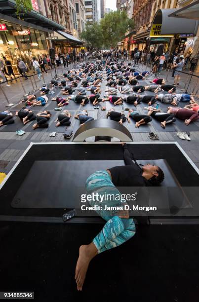 Sunshine Zerda, a yoga instructor takes a class for Sydneysiders in a mass session on Pitt Street in Sydney's CBD during the evening rush hour on...