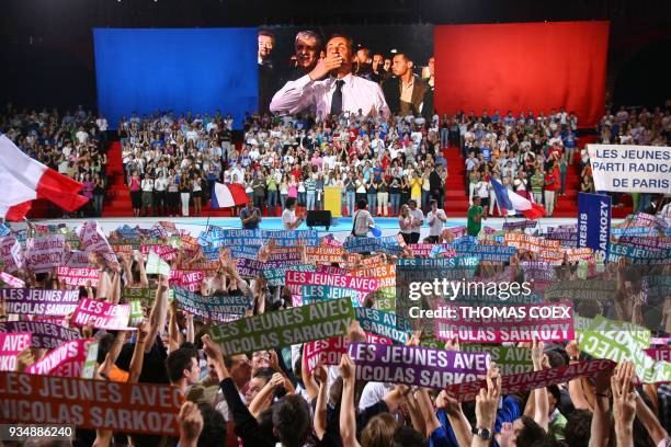 Supporters cheer as they see French right-wing party UMP presidential candidate Nicolas Sarkozy arriving for his meeting 29 April 2007 at the...