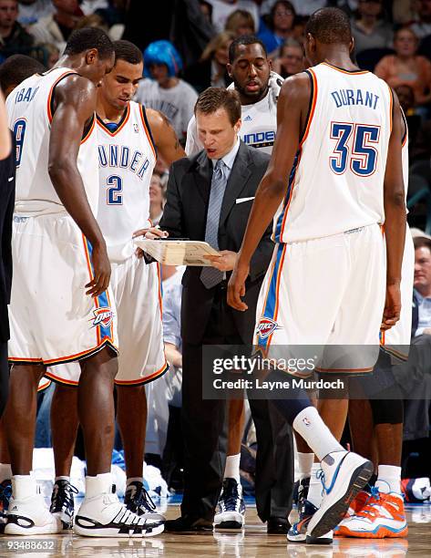 Scott Brooks, Head Coach of the Oklahoma City Thunder shows a play to Thunder Players Serge Ibaka, Thabo Sefolosha, D.J. White, and Kevin Durant...