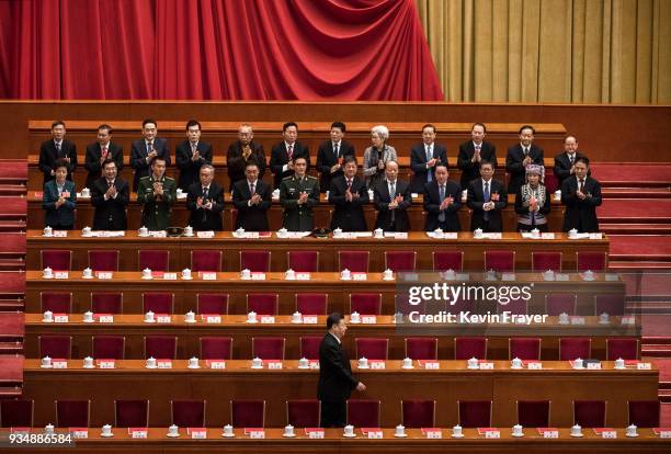 China's President Xi Jinping, bottom, is applauded as he arrives to the closing session of the National People's Congress at The Great Hall Of The...