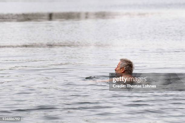 Gustav Meierl and his brother Waldemar Meierl swim in a lake near Biebesheim am Rhein in minus 2 degrees Celcius air temperature on March 19, 2018 in...