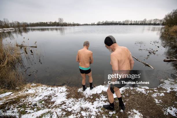 Gustav Meierl and his brother Waldemar Meierl swim in a lake near Biebesheim am Rhein in minus 2 degrees Celcius air temperature on March 19, 2018 in...