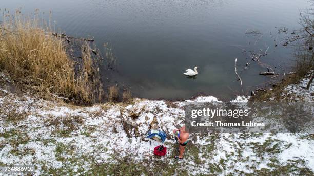 Gustav Meierl and his brother Waldemar Meierl swim in a lake near Biebesheim am Rhein in minus 2 degrees Celcius air temperature on March 19, 2018 in...