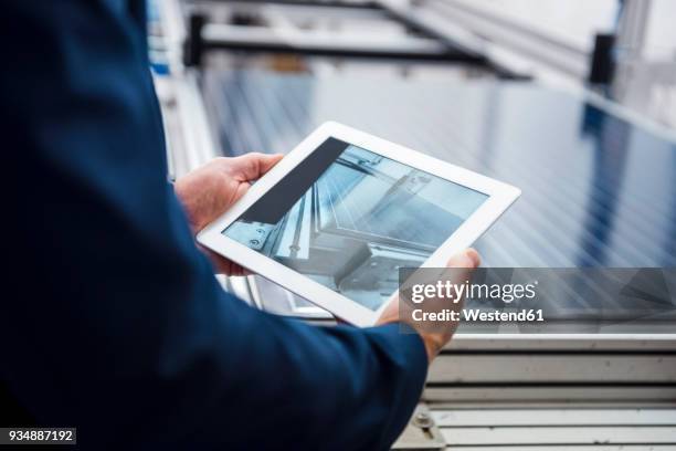 businessman in solar factory holding tablet - digitalisering bildbanksfoton och bilder
