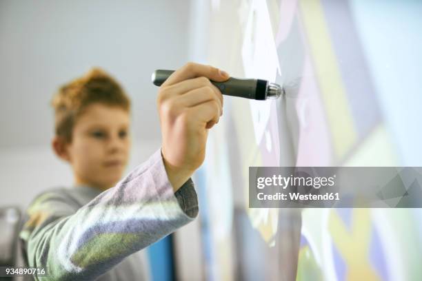 student in class using digitized pen at interactive whiteboard - interaktives whiteboard stock-fotos und bilder