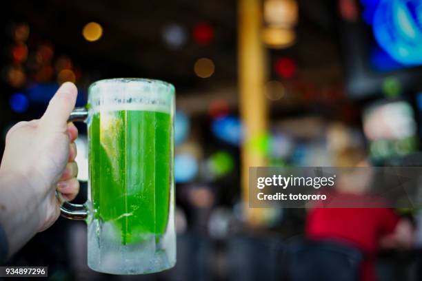 saint patrick day celebration with green theme at local irish bar in vancouver bc canada - st patricks celebration stock pictures, royalty-free photos & images