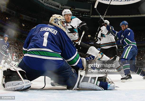 Roberto Luongo of the Vancouver Canucks makes a blocker save off a shot by Joe Pavelski of the San Jose Sharks during their game at General Motors...