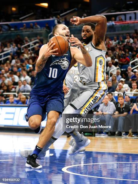 Evan Fournier of the Orlando Magic goes up for a lay-up over Tristan Thompson of the Cleveland Cavaliers during the game at the Amway Center on...