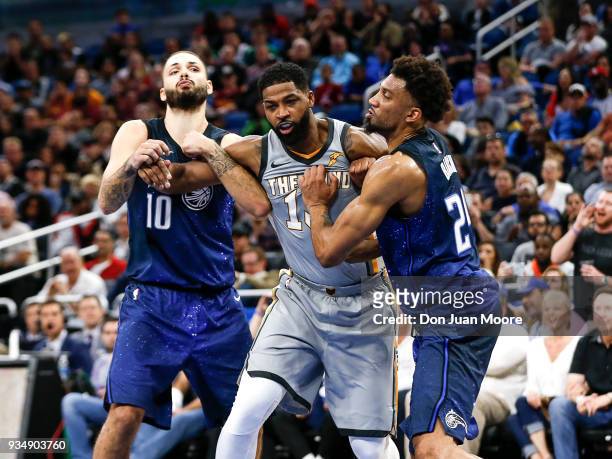 Tristan Thompson of the Cleveland Cavaliers battles Evan Fournier and Khem Birch of the Orlando Magic during the game at the Amway Center on February...