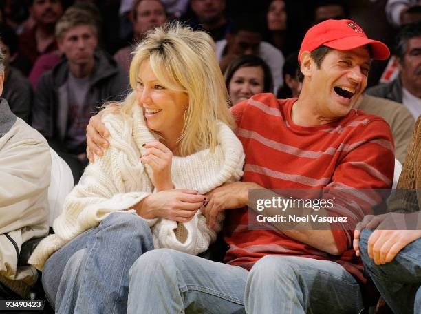 Heather Locklear and Thomas Calabro attend a game between the New Jersey Nets and the Los Angeles Lakers at Staples Center on November 29, 2009 in...