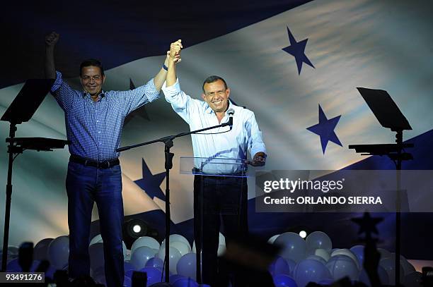 The president-elect of Honduras, Porfirio Lobo greets supporters with former president Rafaek Leonardo Callejas in Tegucigalpa, on November 30, 2009....